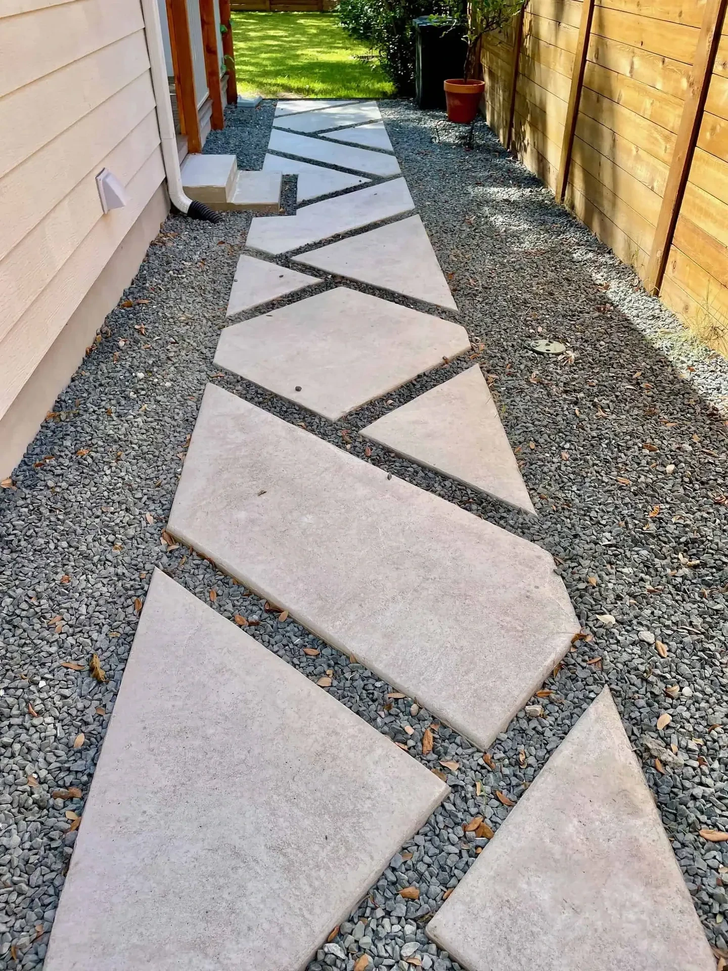 Tiered Corten steel retaining walls with marbled concrete slabs and specimen Whale's Tongue Agaves — Westlake Hills Austin TX