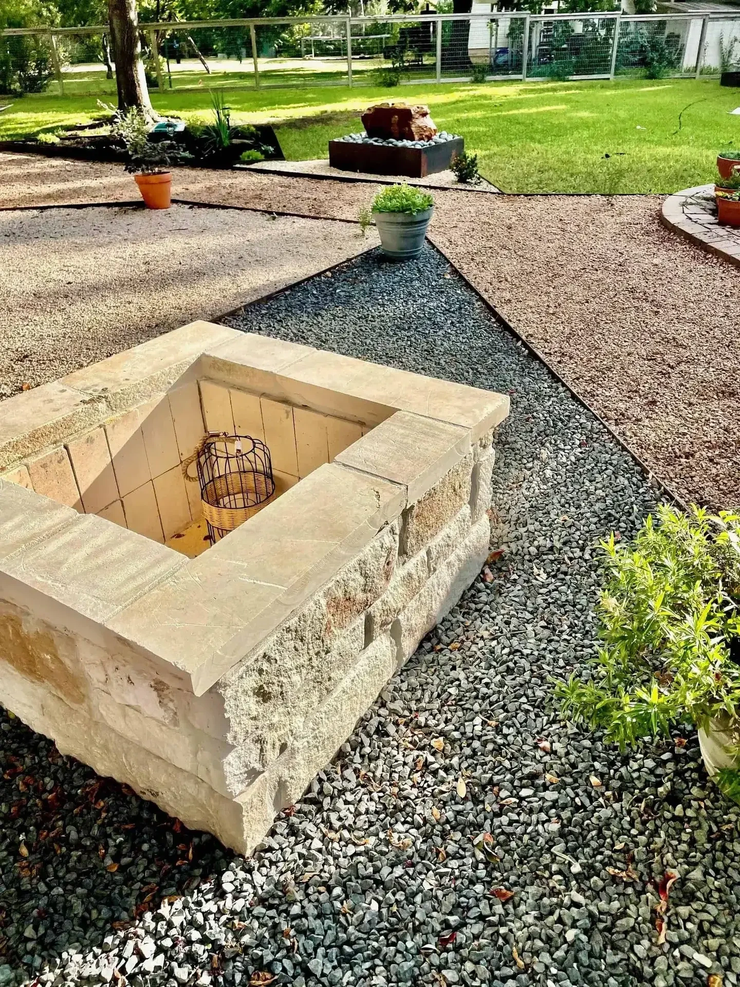 Stone masonry fire pit with gravel hardscape Austin TX