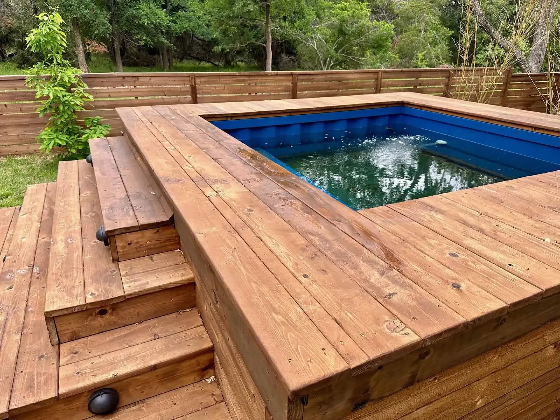 Raypak R8450ti heat/cool pump housed in ventilated cedar equipment enclosure — Barton Creek Austin TX