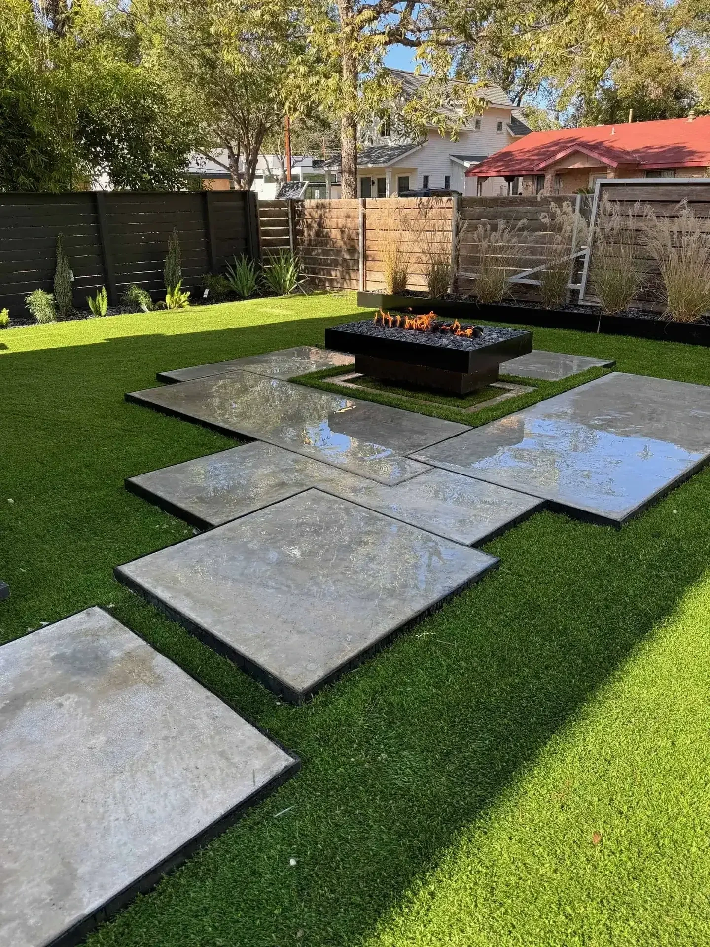 Artificial turf with concrete stepping pads and fire pit Austin TX