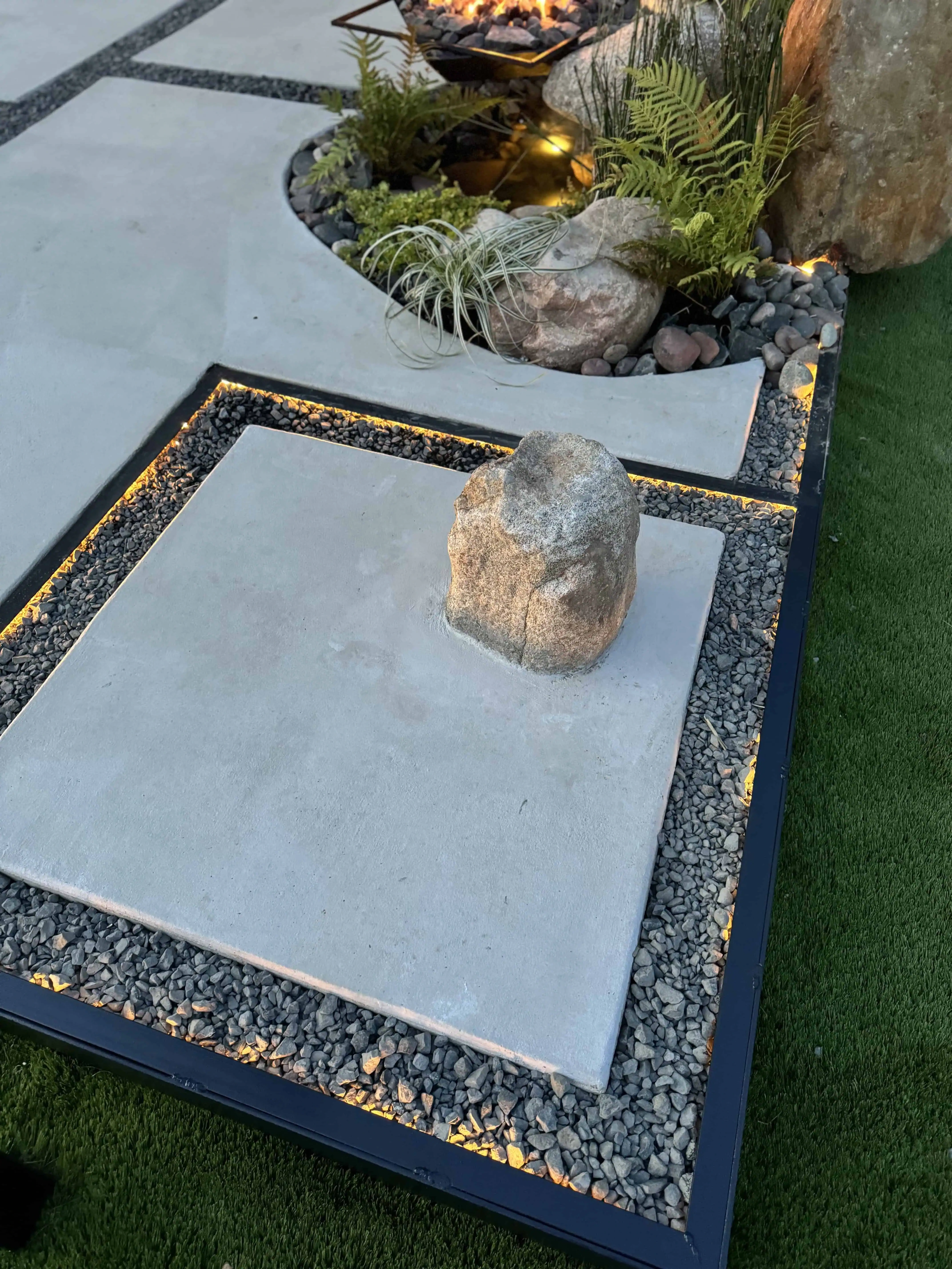 Decomposed granite pathway with hand-set limestone boulders and steel edging transitions — Pflugerville TX