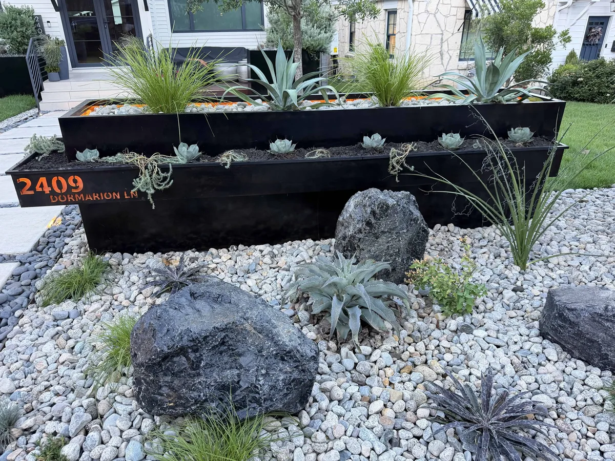 Dormarion — cantilevered steel planters with CNC-cut address sign, copper backing, COB lighting, boulders, Mexican beach pebbles — Tarrytown Austin TX — Red Agave Landscape