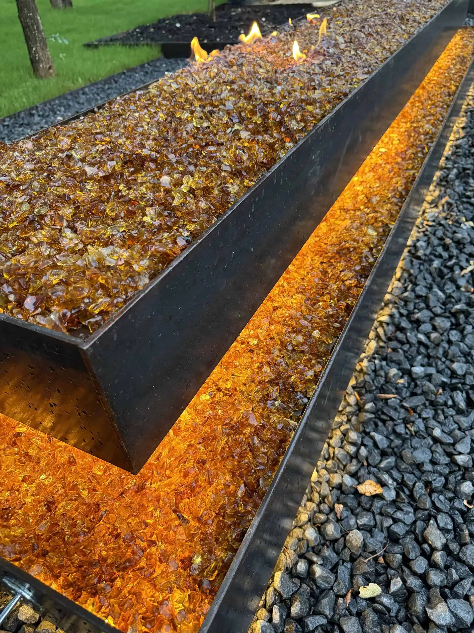 Amber fire glass detail — welded steel fire pit — Austin TX