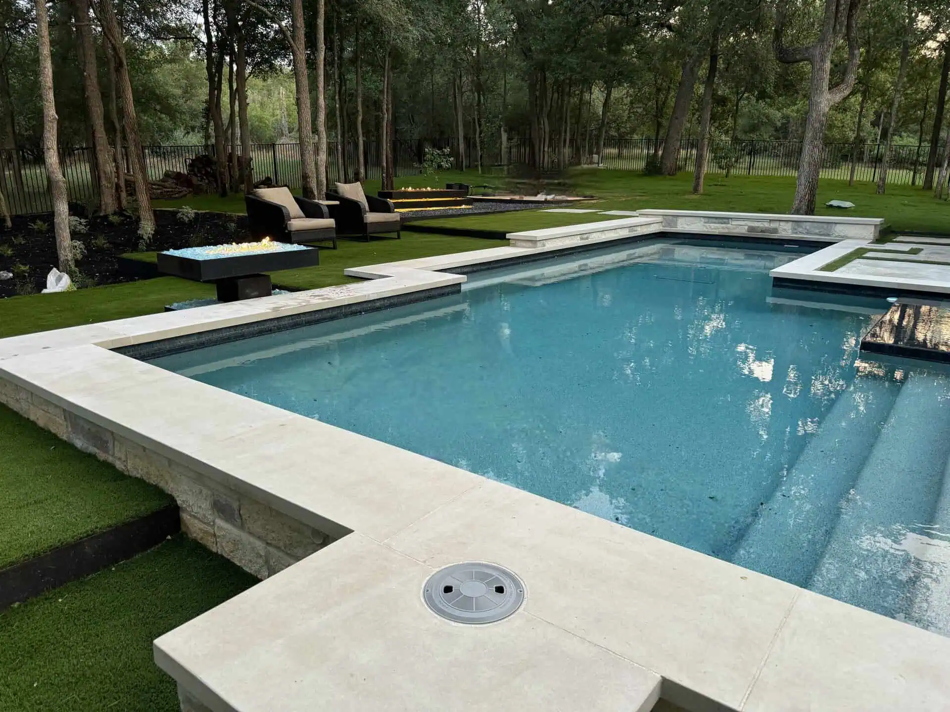 Custom inground pool with turf joints and fire pit Austin TX