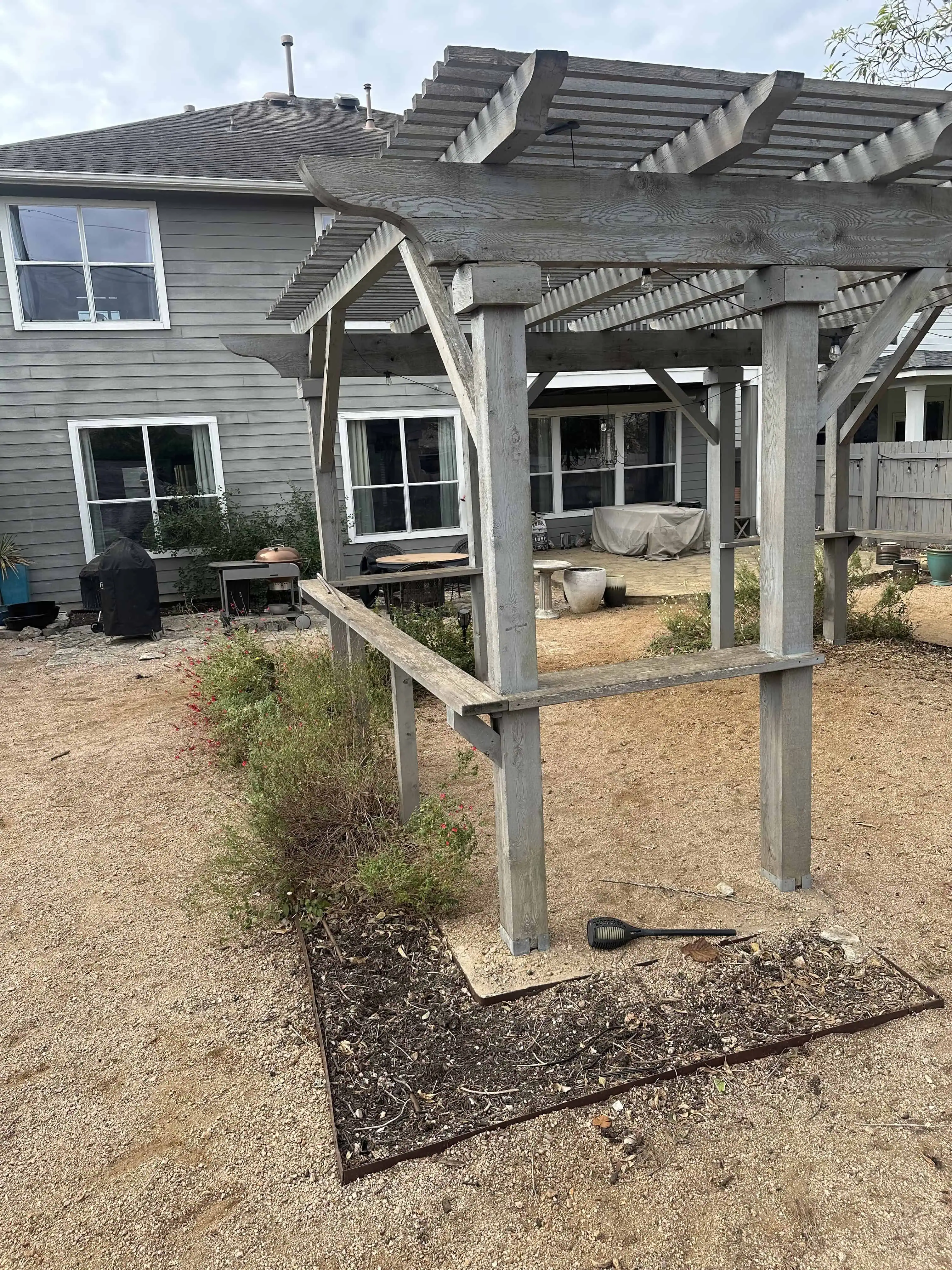 Hopeland before — sun-bleached pergola + failing flagstone patio in Circle C, Austin TX