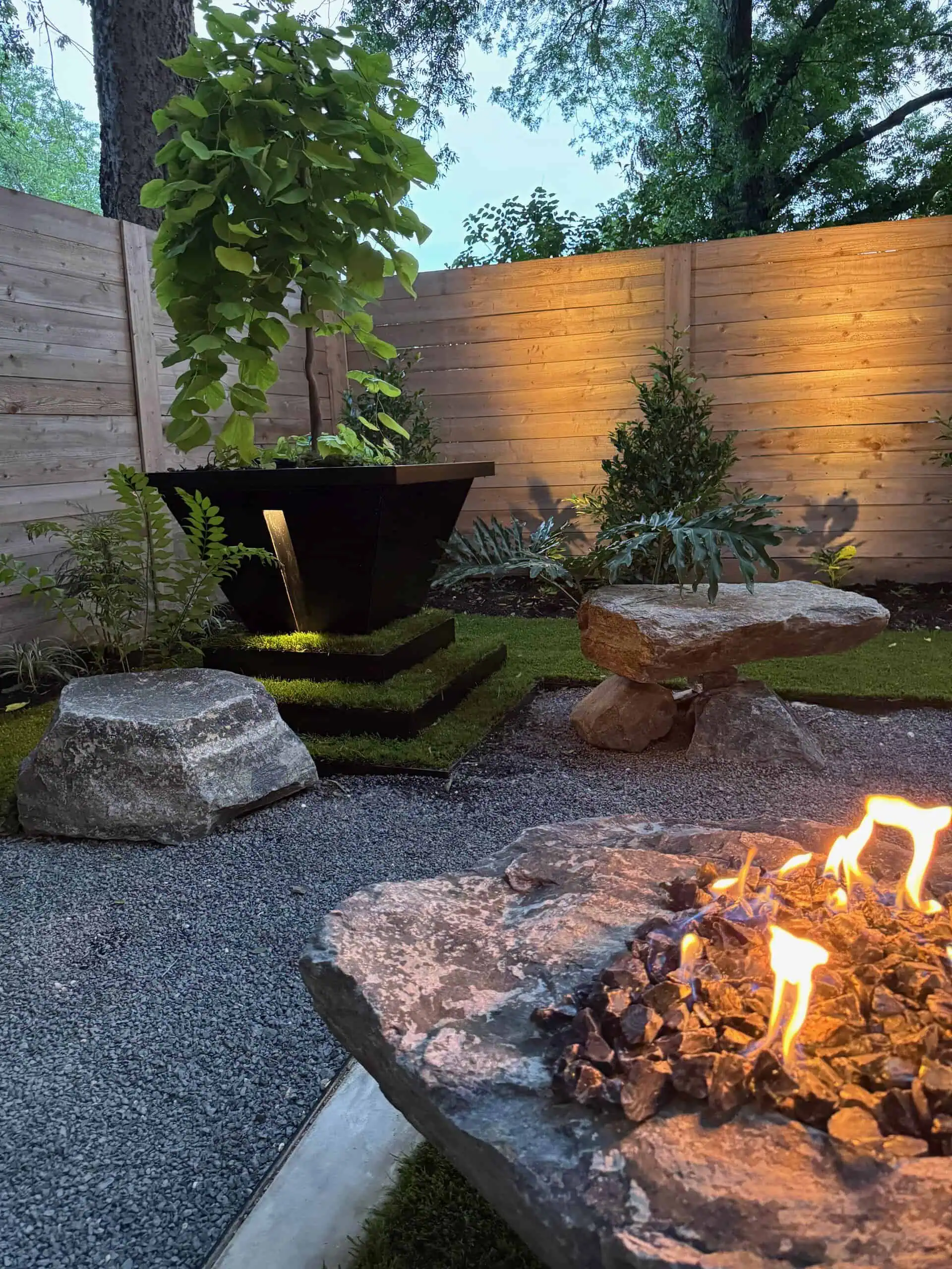 Boulder bench with fire and tiered planter — Austin TX