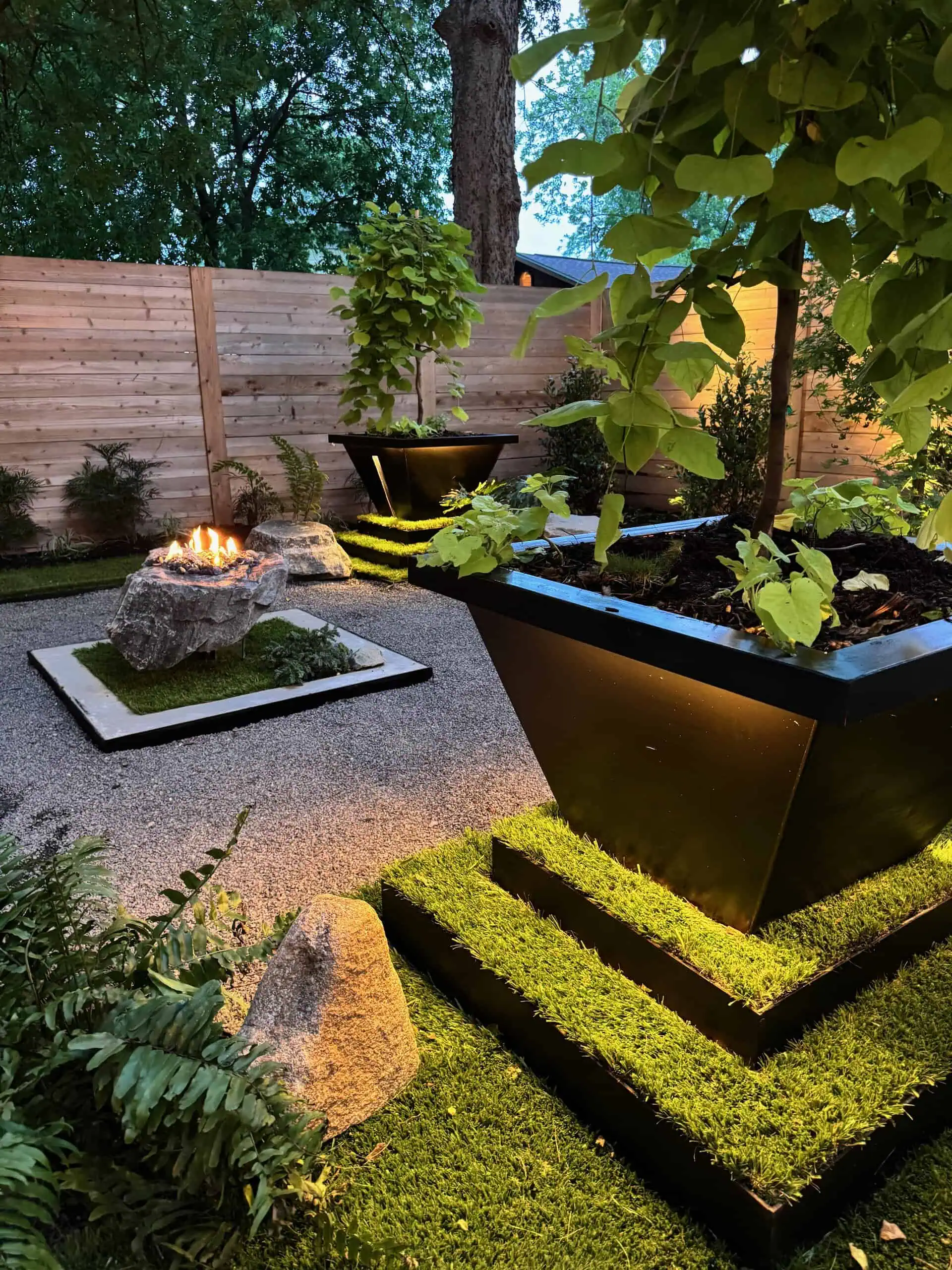 Evening composition — fire, planter, bench — Austin TX