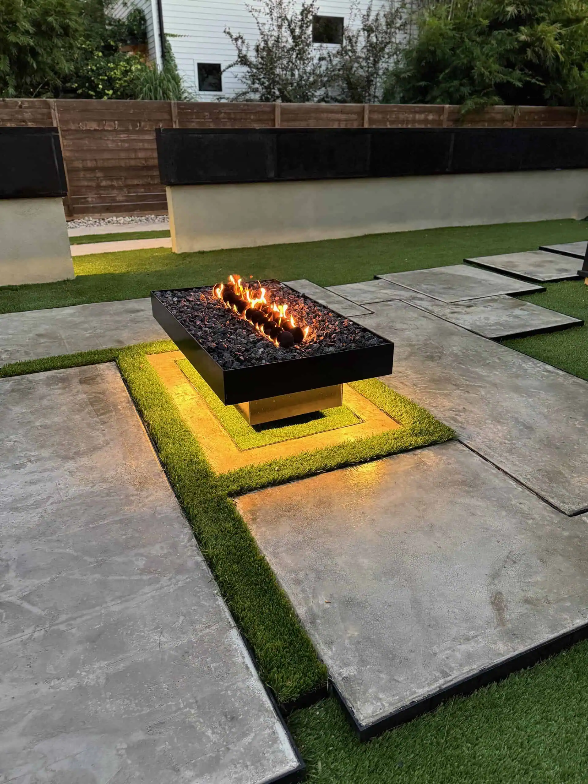 Riverview — floating welded steel fire pit, black cantera wall, concrete poured to look like marble — Austin TX